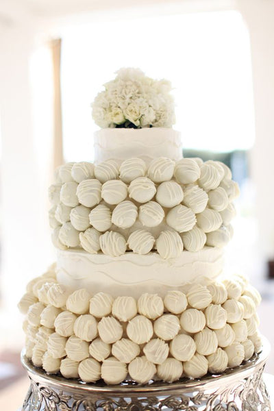 White Cake Pop Wedding Cake with Flower Arrangement on Top