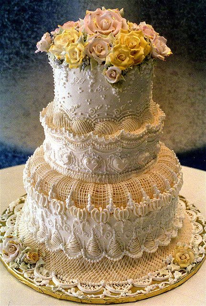 Detailed Victorian Wedding Cake with Roses on Top