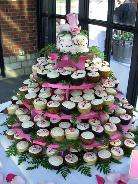 Large Wedding Cupcake Tower with flower and fern garnish.