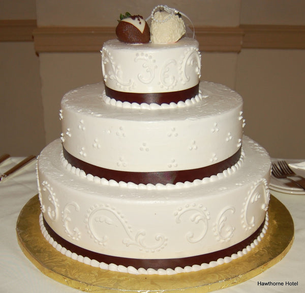 White Wedding Cake with Bride and Groom Strawberries Dipped in Chocolate