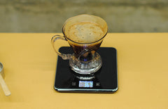 Coffee steeping in brewer on top of scale