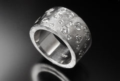 Recycled 14k white gold flat band with reused flush set diamonds