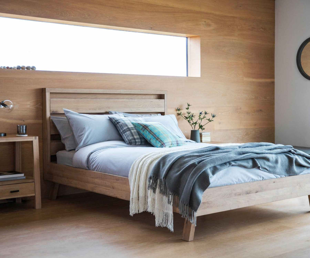 Wooden bedroom with throw in wooden clad bedroom