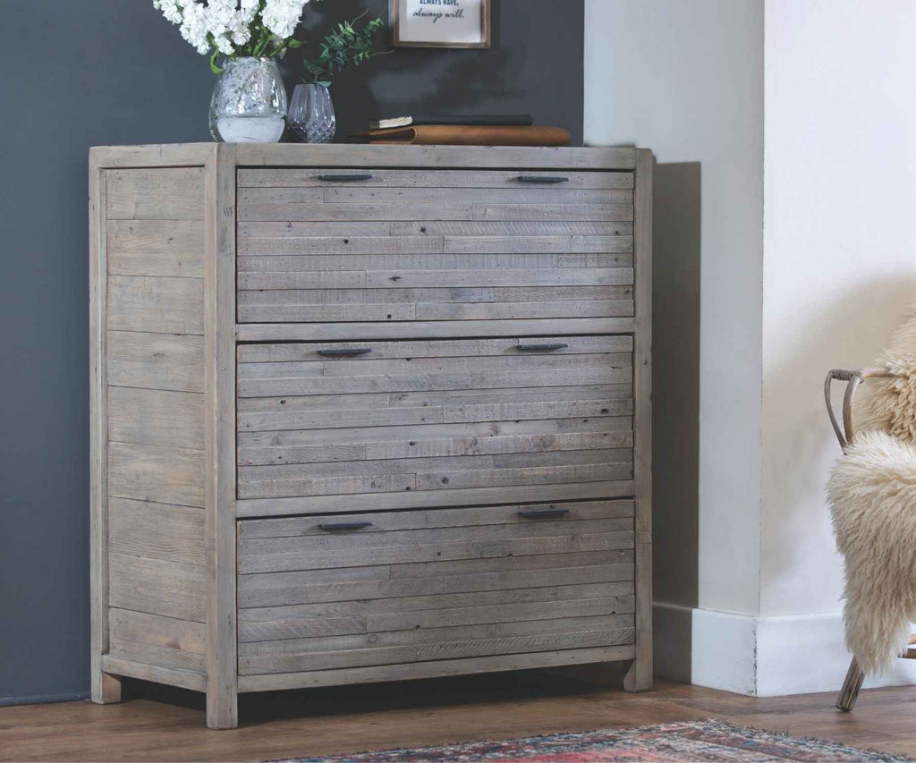 Reclaimed wood chest of drawers against blue wall