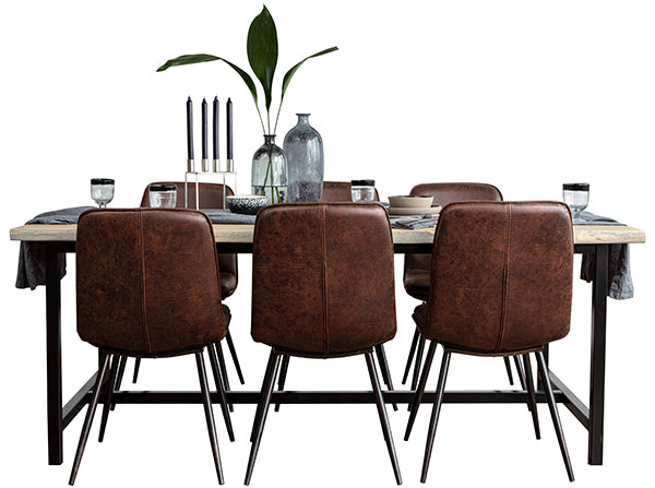 An industrial and rustic oak dining table with an H bar and tan dining chairs