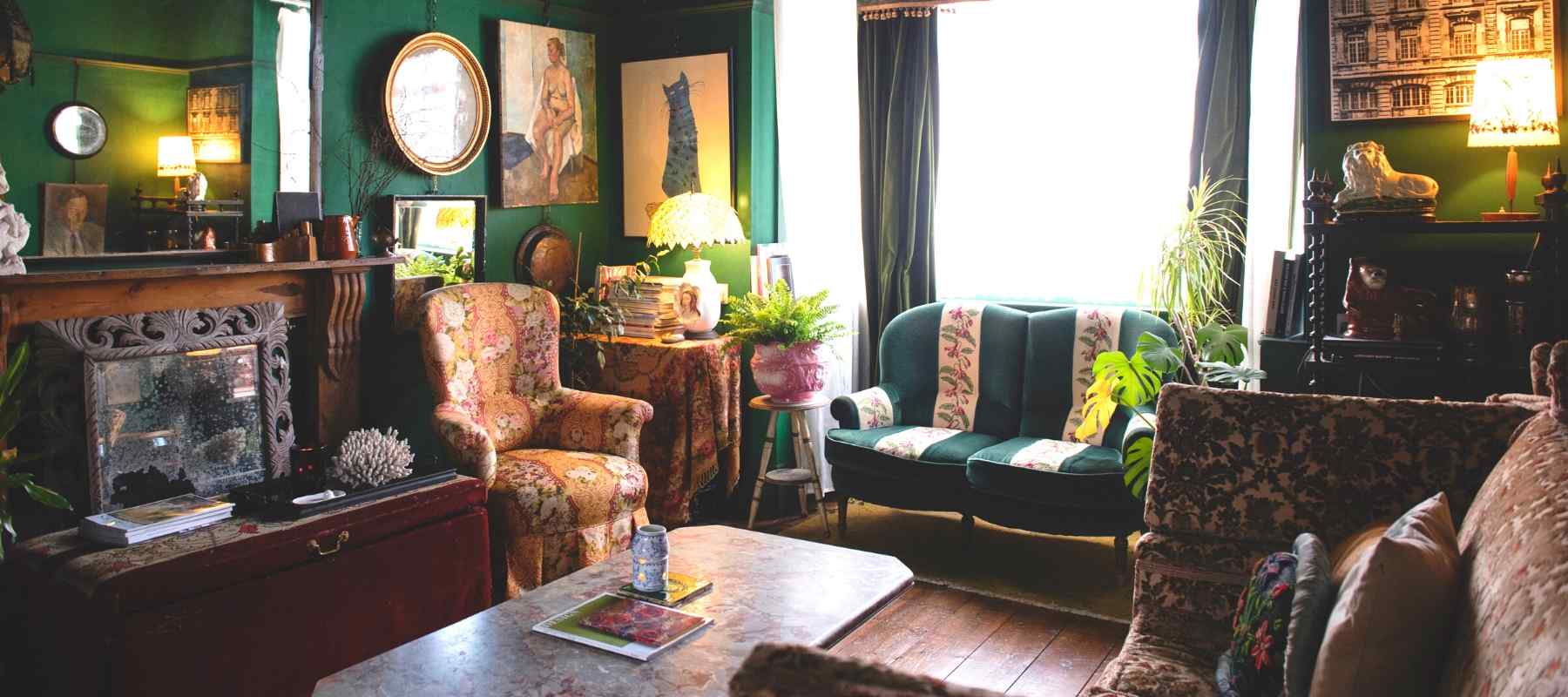 Green lounge decorated with vintage wooden furniture