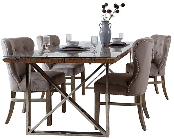 Four taupe velvet dining chairs around a luxurious dining table