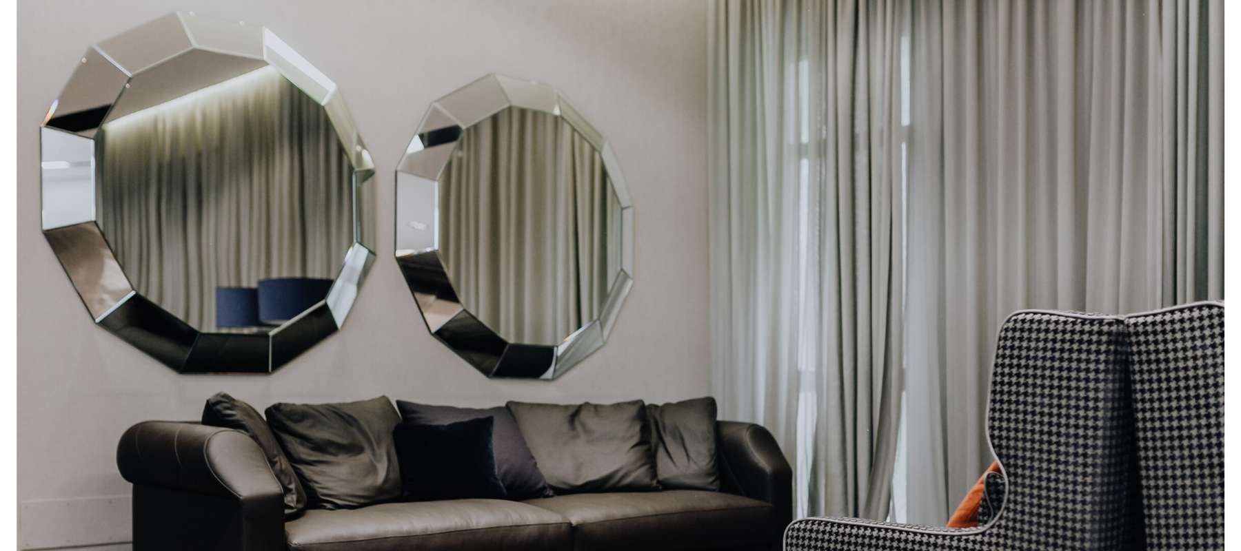 Two large hexagonal mirrors on living room wall