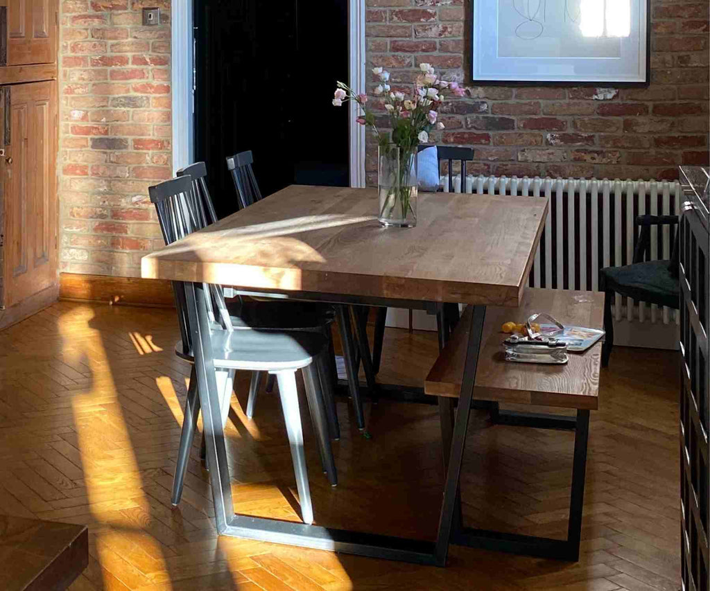 Industrial dining table with black metal legs and dark wood dining chairs
