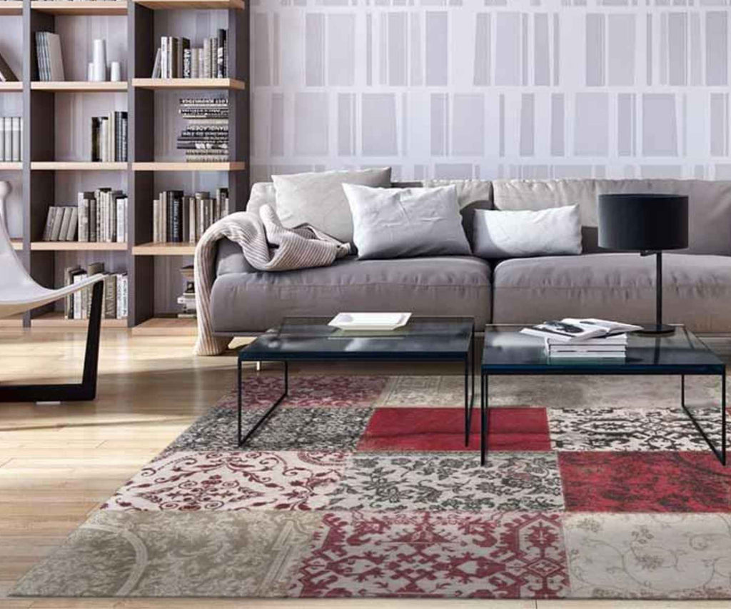 Grey sofa with large patchwork red rug