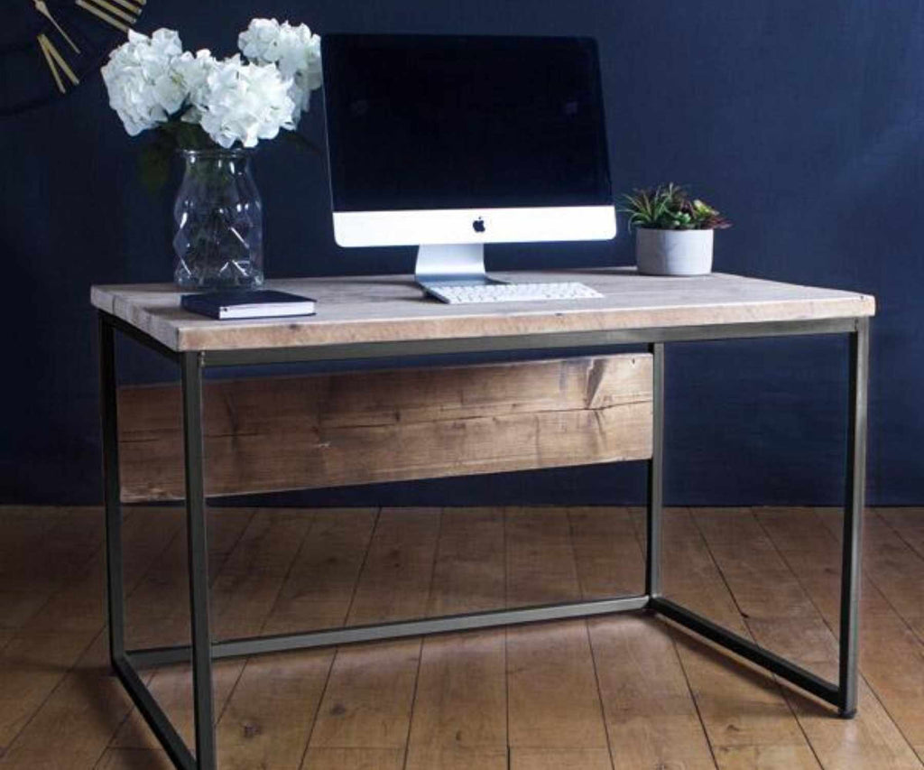 Mac sat on industrial reclaimed wood desk with white flowers