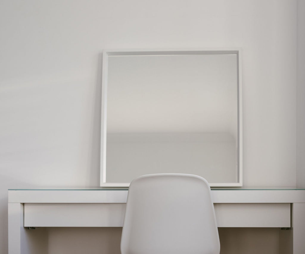 White desk , chair and mirror in empty room