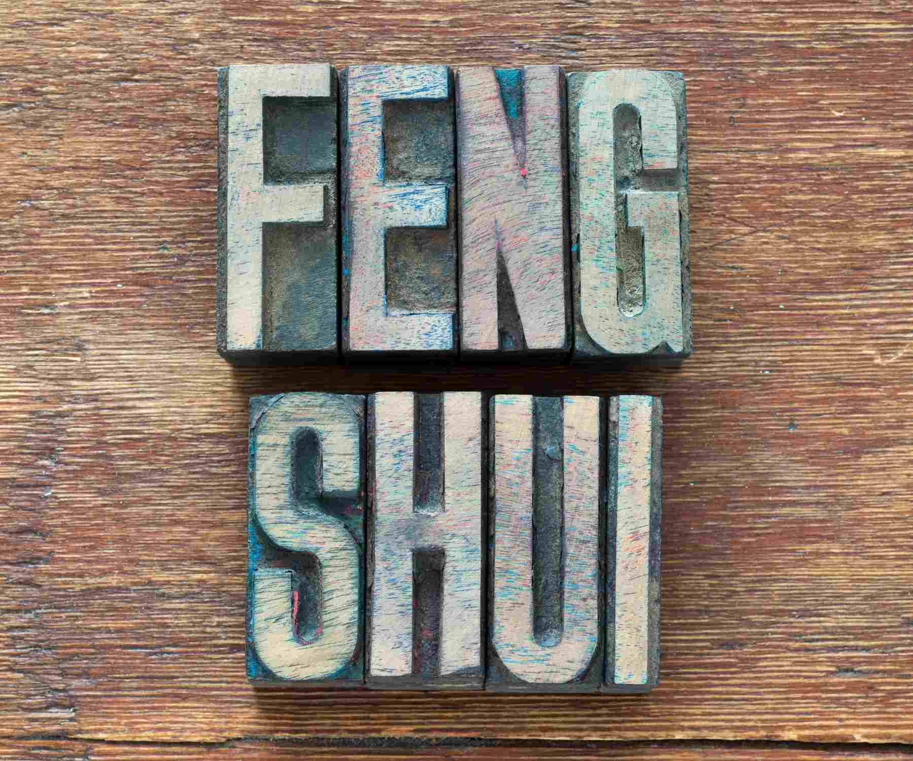 Word feng shui is large wood letters on wooden surface