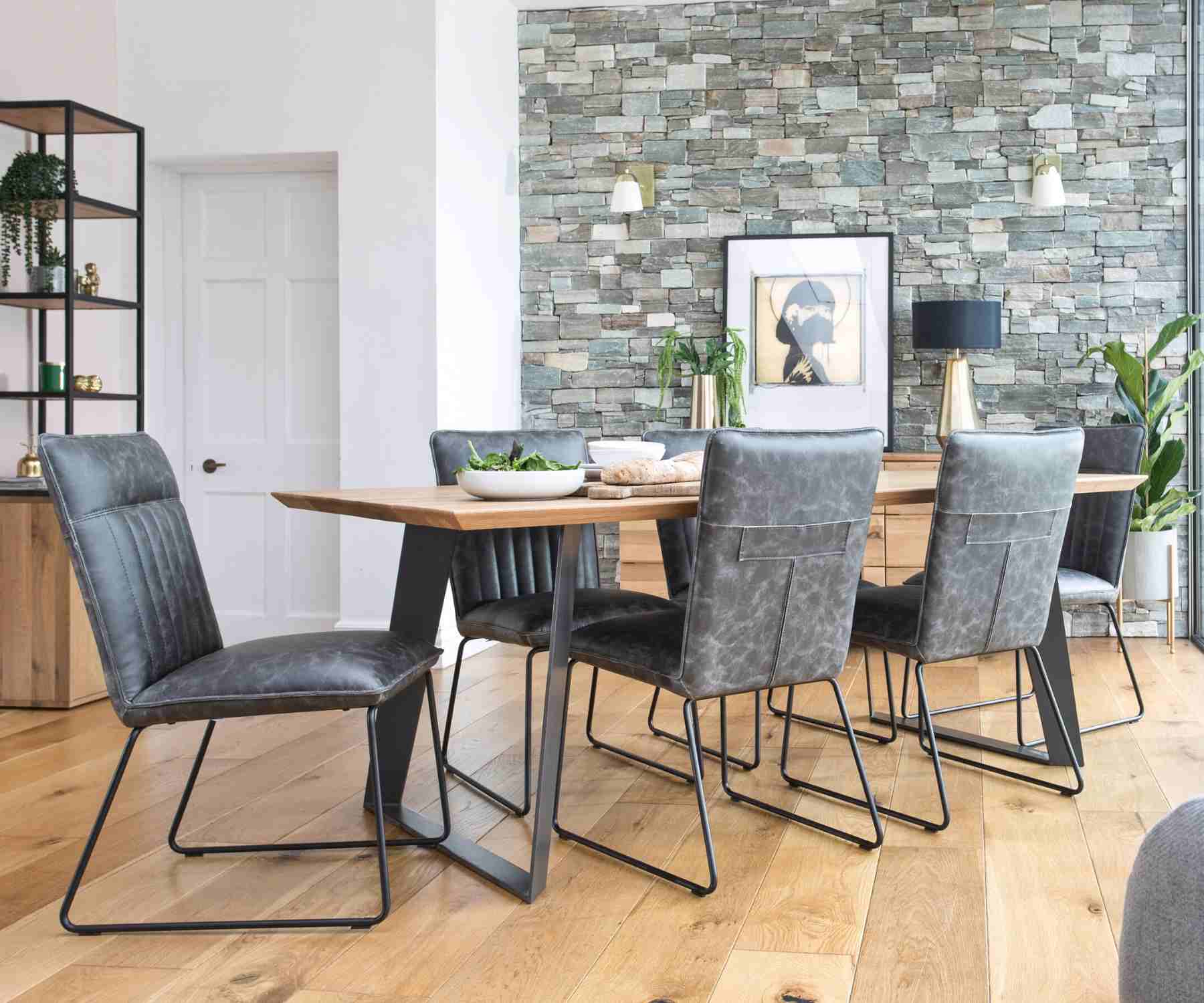 Grey faux leather dining chairs with industrial table