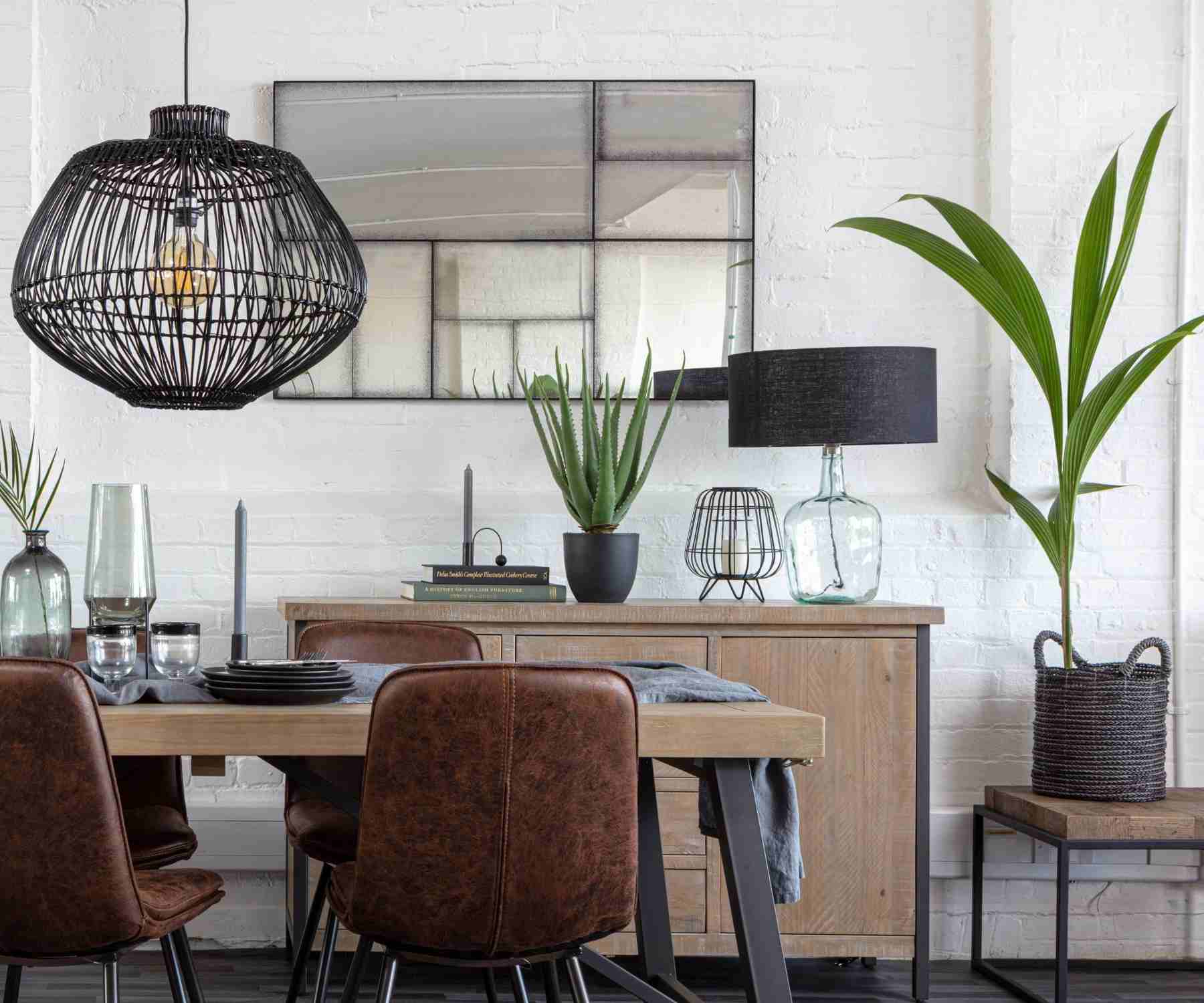 Reclaimed wood dining table with faux leather chairs and black pendant light