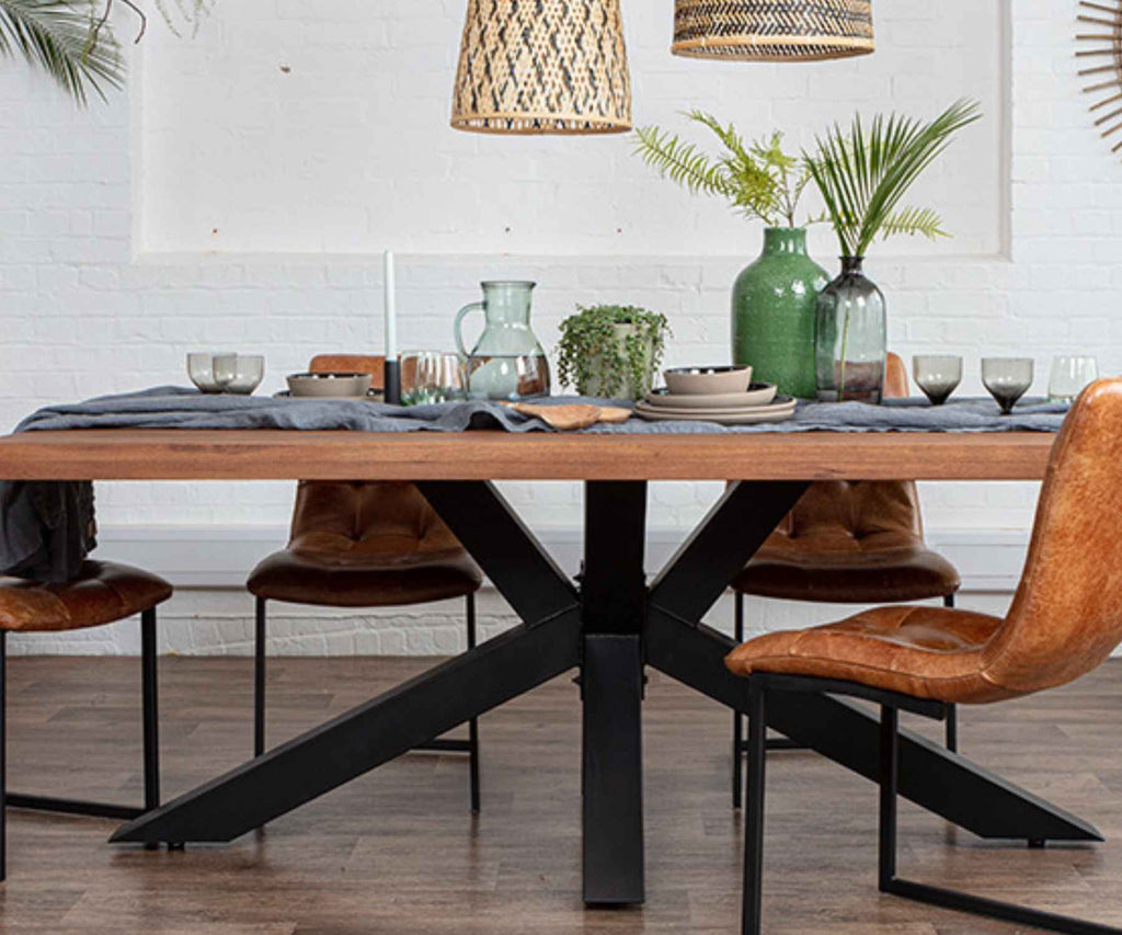 Spider leg wooden dining table with brown industrial dining chairs