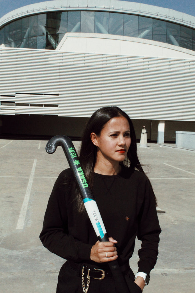 Image of Robyn Johnson holding an Osaka brand field hockey stick