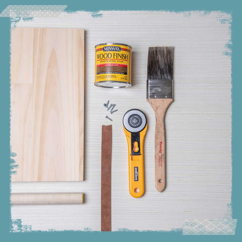 Wood, dowels, a can of wood stain, a paint brush, a rotary cutter. 