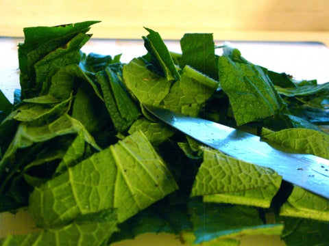 Cut up comfrey leaves.