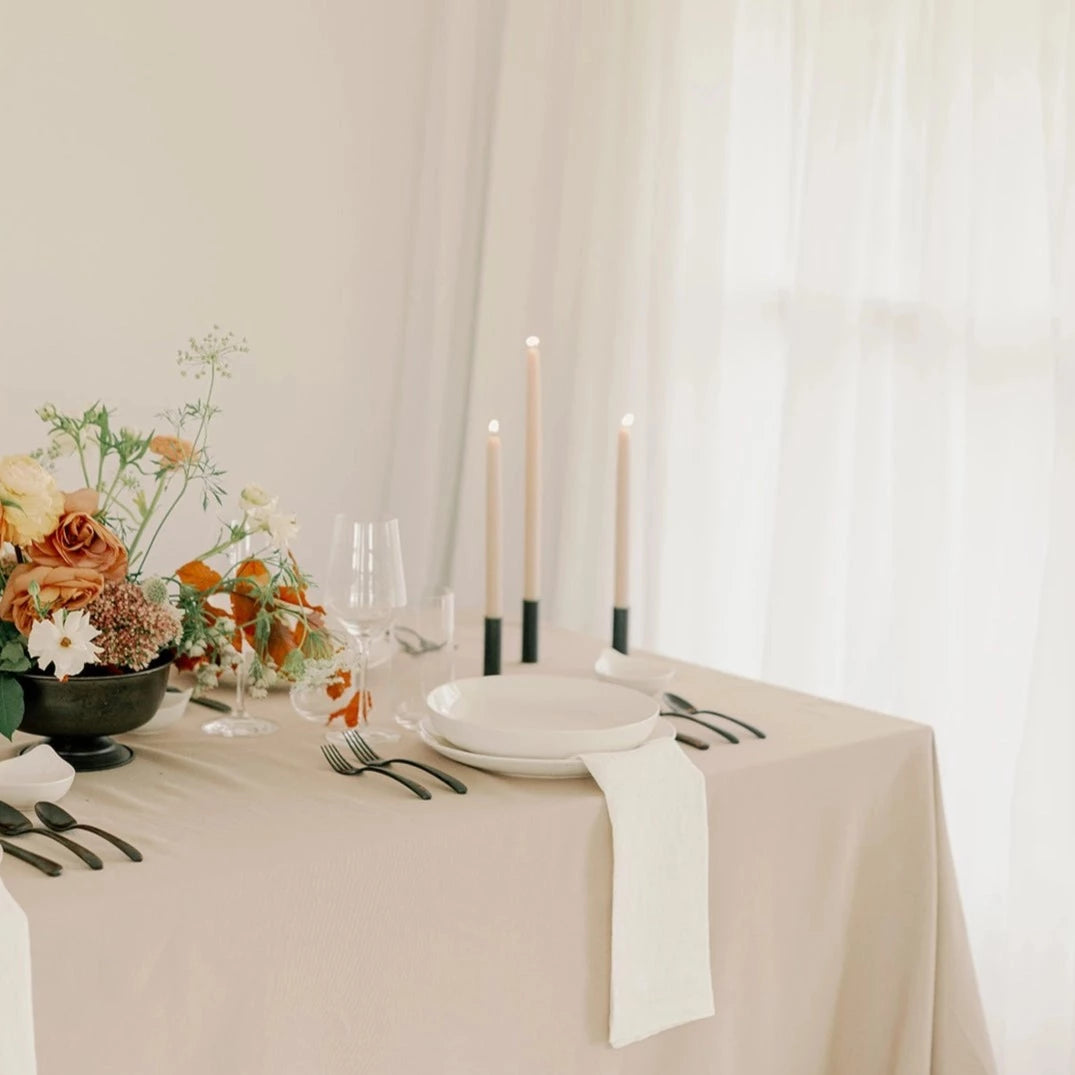 Mo&Co. Home Hand-Dipped Tapers in Clay, styled on a table.