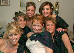 A bride & her bridesmaids in tartans & celtic brooches