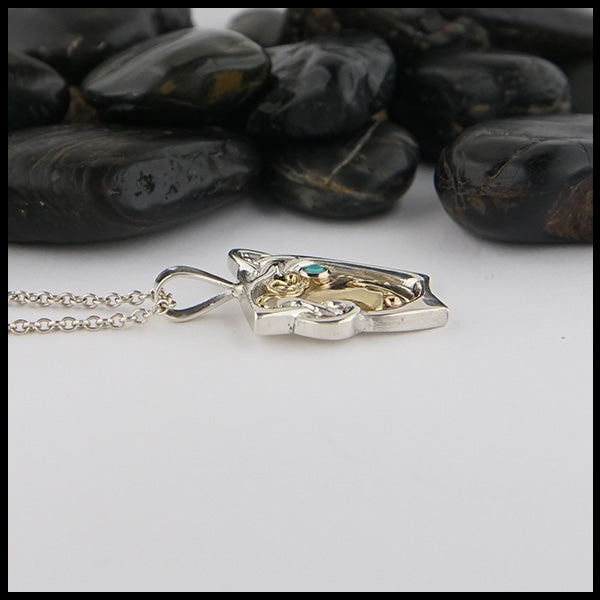 Profile view of custom pendant in Sterling Silver and 18K Yellow Gold, set with a 2mm Turquoise stone.