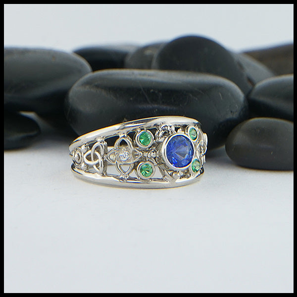 Custom Celtic Starlight ring has a 14K White Gold frame set with a 5.0mm Ceylon Sapphire, four 2mm Tsavorite Garnets, and two 1.5mm Diamonds.