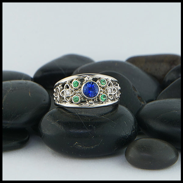 Custom Celtic Starlight ring has a 14K White Gold frame set with a 5.0mm Ceylon Sapphire, four 2mm Tsavorite Garnets, and two 1.5mm Diamonds.