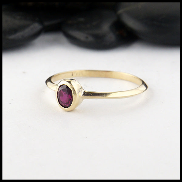 Simple 14K Yellow Gold ring bezel set with a 0.47ct 5x4mm oval Ruby.