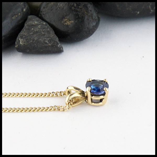 5mm Ceylon Blue Sapphire set in a 14K yellow gold setting with an 18" 14K Yellow Gold light curb chain.