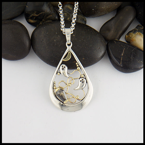 Custom Ghost Pendant in Sterling Silver featuring silver ghosts and 14K Yellow gold moon, ghost trails, and accent beads.  The coffin shaped salt and pepper diamond is 0.63 ct measuring 7.3mm x 4.9mm. 