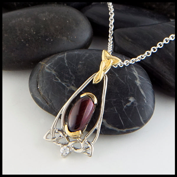Profile view Oval Garnet and Trinity Knot Gold Pendant