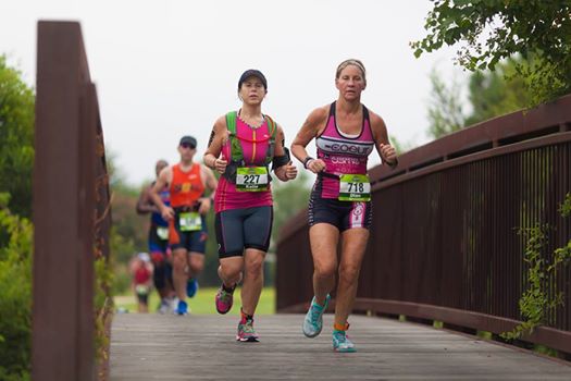 Women running over a bridge