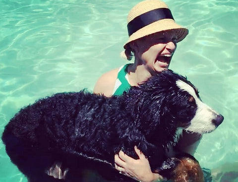 Coeur Sports Founder Kebby Holden in pool with dog