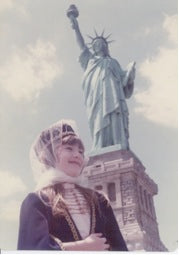 Suhein Beck in 1974 in front of Statue of Liberty wearing her Circassian Ethnic Dress 