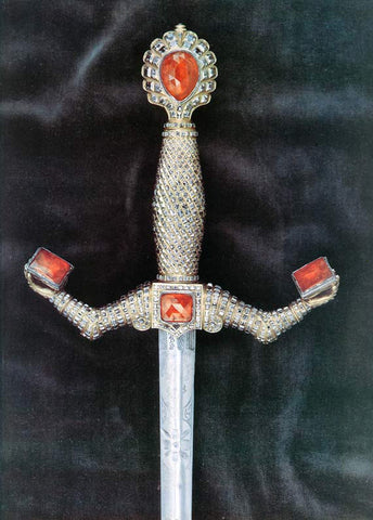 Jeweled sword hilt with anatomical arms.