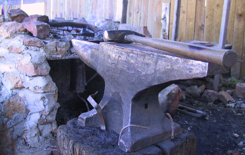 Picture of hammer resting on anvil at MN Ren Fair by forge.