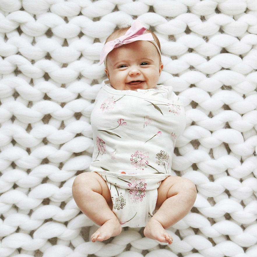 laughing baby in organic swaddle blanket