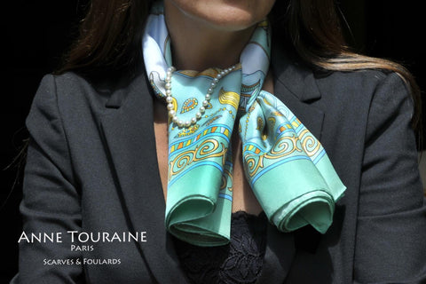 French silk scarf, neon green by ANNE TOURAINE Paris™ tied around the neck with a pearl necklace