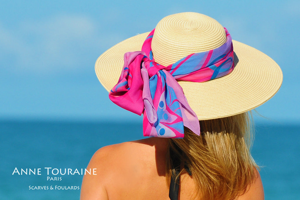 Extra large silk chiffon scarves by ANNE TOURAINE Paris™: pink and blue wrapped and tied with a fluffy knot around a hat