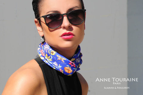 Floral blue silk scarf by ANNE TOURAINE Paris™ criss crossed to create a fluffy neck scarf