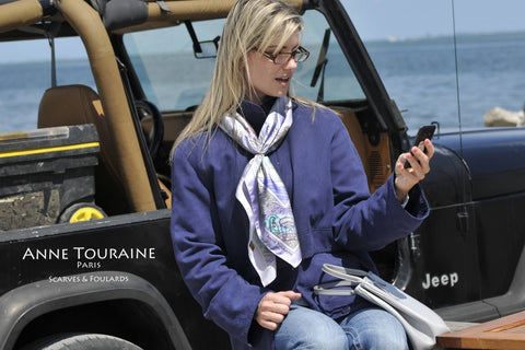 French silk scarf, Paris theme, blue color, by ANNE TOURAINE Paris™ tied around the neck in a casual way