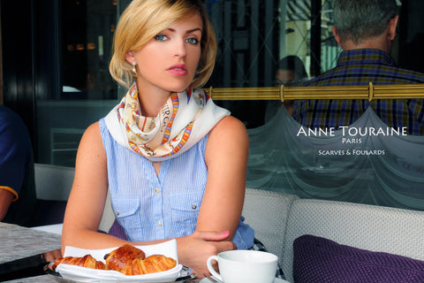 French silk scarf, astrology zodiac theme, white color, by ANNE TOURAINE Paris™ tied in a casual way around the neck 