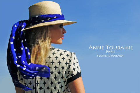 ANNE TOURAINE Paris™ scarves: blue polka dot silk scarf tied around a straw hat