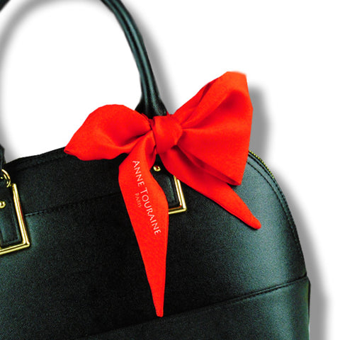 twillies by ANNE TOURAINE Paris™; red twilly tied around a black handbag