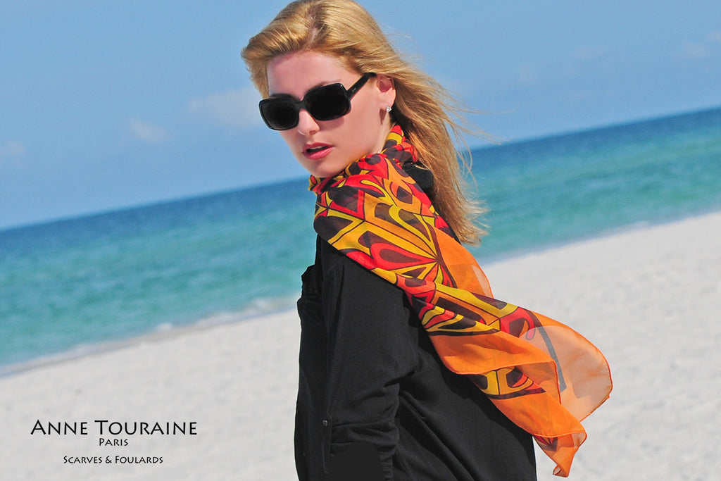 Extra large silk chiffon scarves: orange and black scarf around the neck and tilted to the side