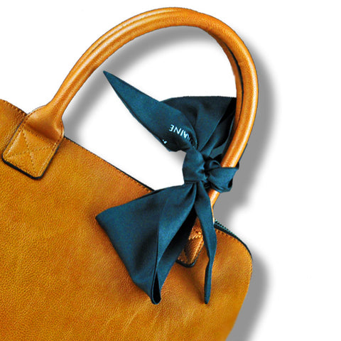 twillies by ANNE TOURAINE Paris™; black twilly tied around a brown handbag