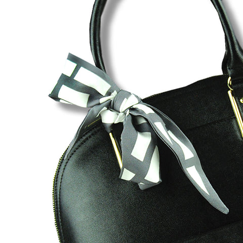 twillies by ANNE TOURAINE Paris™; grey and white twilly tied on a black handbag