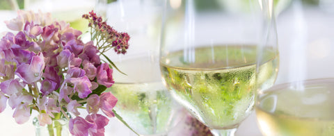 white wine glasses with purple summer flowers