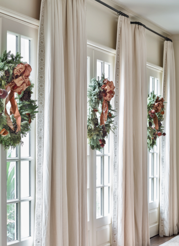 Designer Lynne Rankin centered three simple and elegant wreaths on these French doors. (<a href="https://atlantahomesmag.com/article/winters-embrace/" target="_blank">Atlanta Homes and Lifestyles</a>/photography by Emily Followill.)